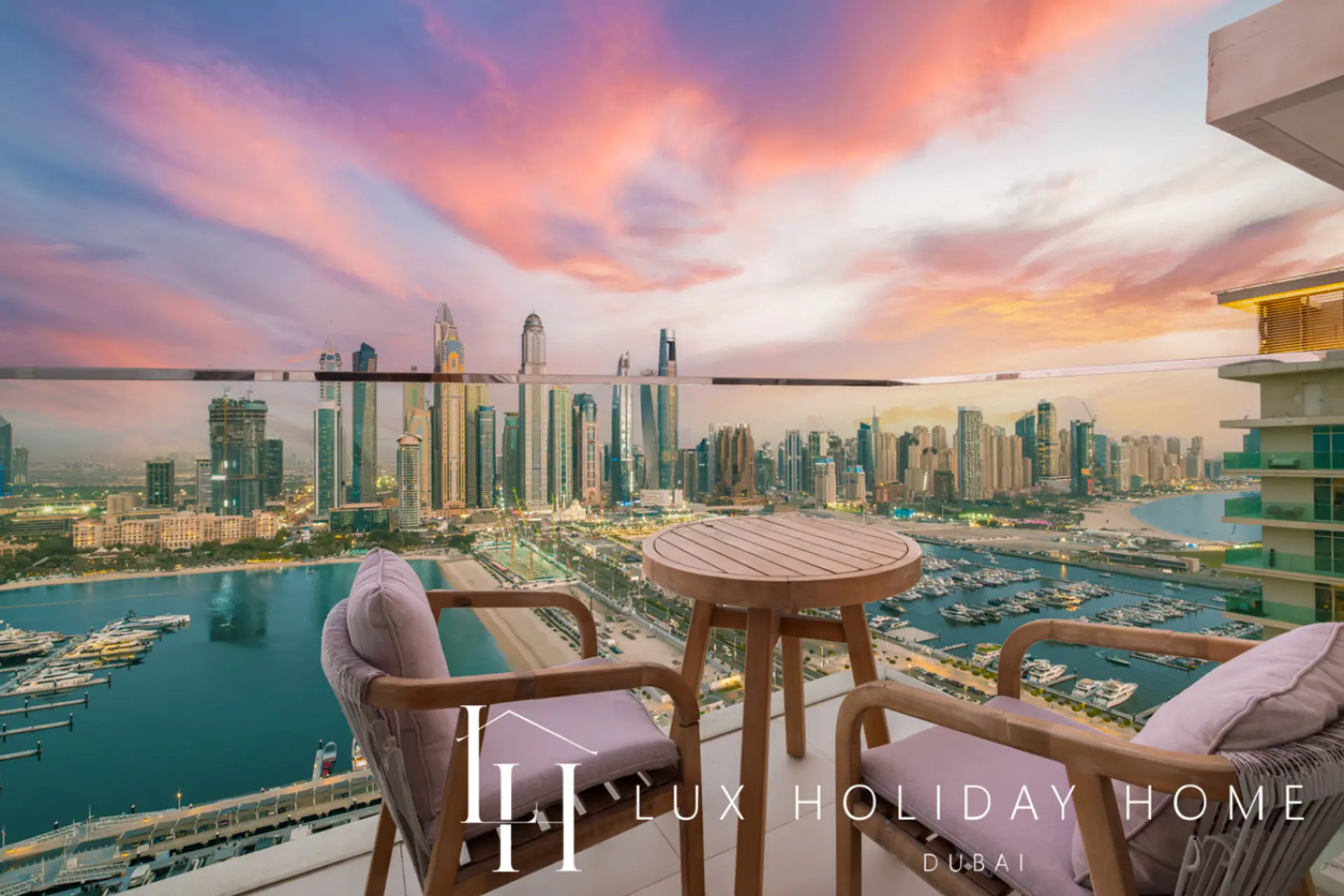 Sunset view of the Dubai Marina skyline from the balcony of LUX Sunrise Beachfront Suite 1
