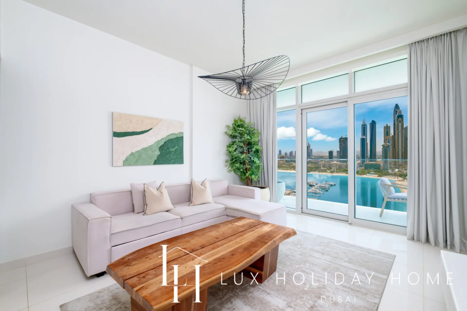 Living room with sea and Marina views at LUX Sunrise Beachfront Suite 1, Dubai