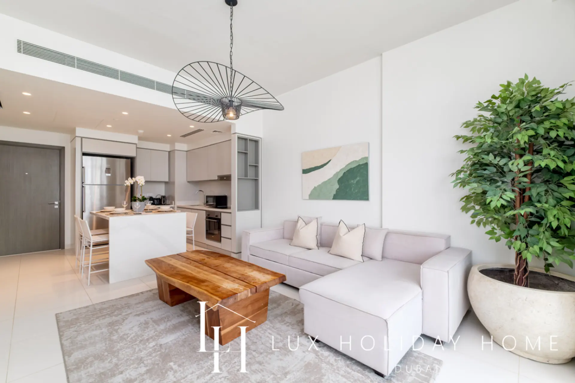 Open-plan living and dining area at LUX Sunrise Beachfront Suite 1, Dubai