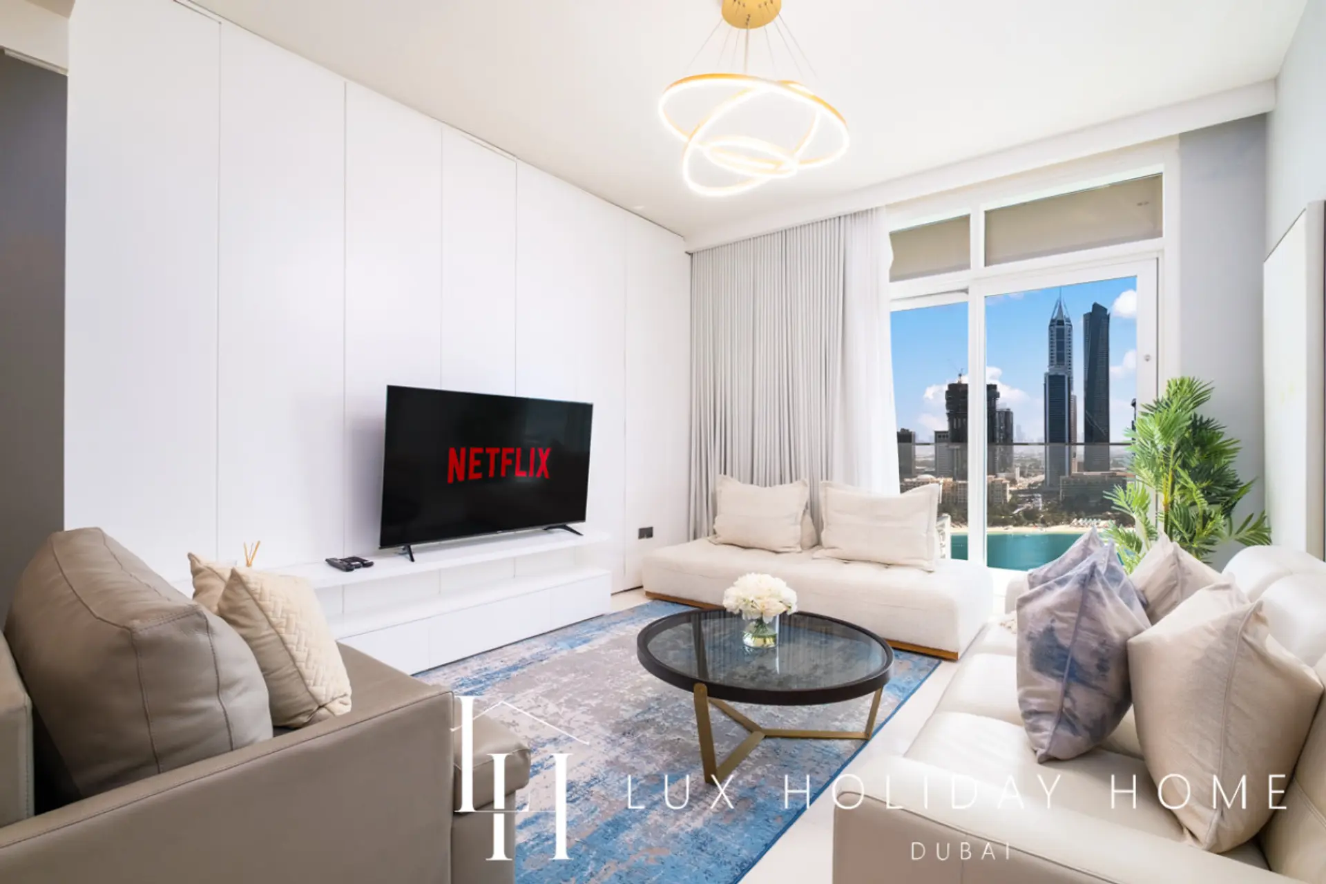 Living room with Netflix-ready TV and beach view at LUX Sunrise Beachfront Suite 2, Dubai