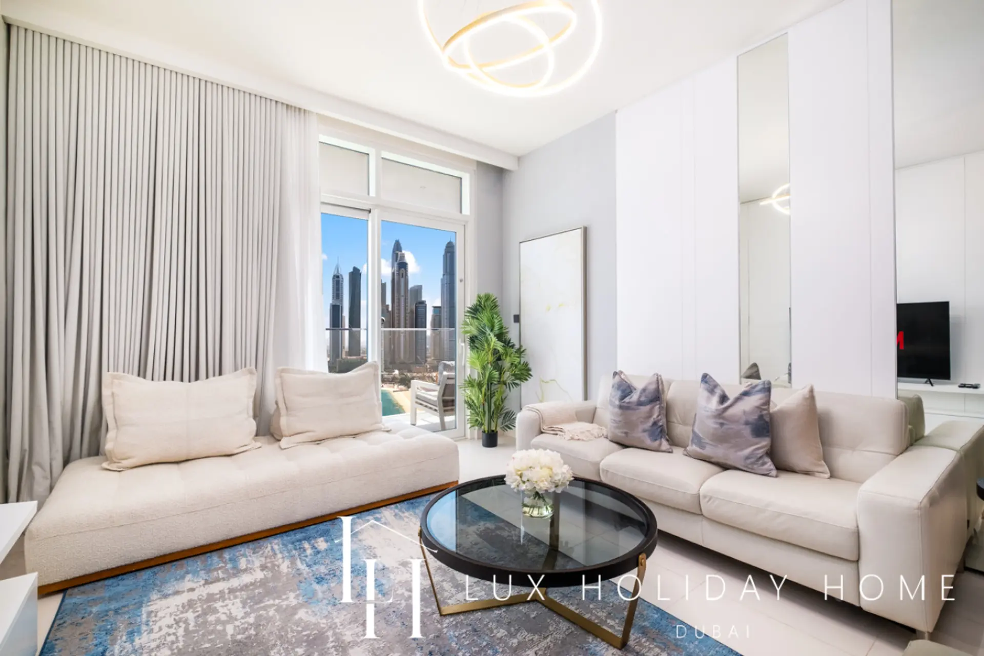 Living room overlooking the Marina skyline at LUX Sunrise Beachfront Suite 2, Dubai